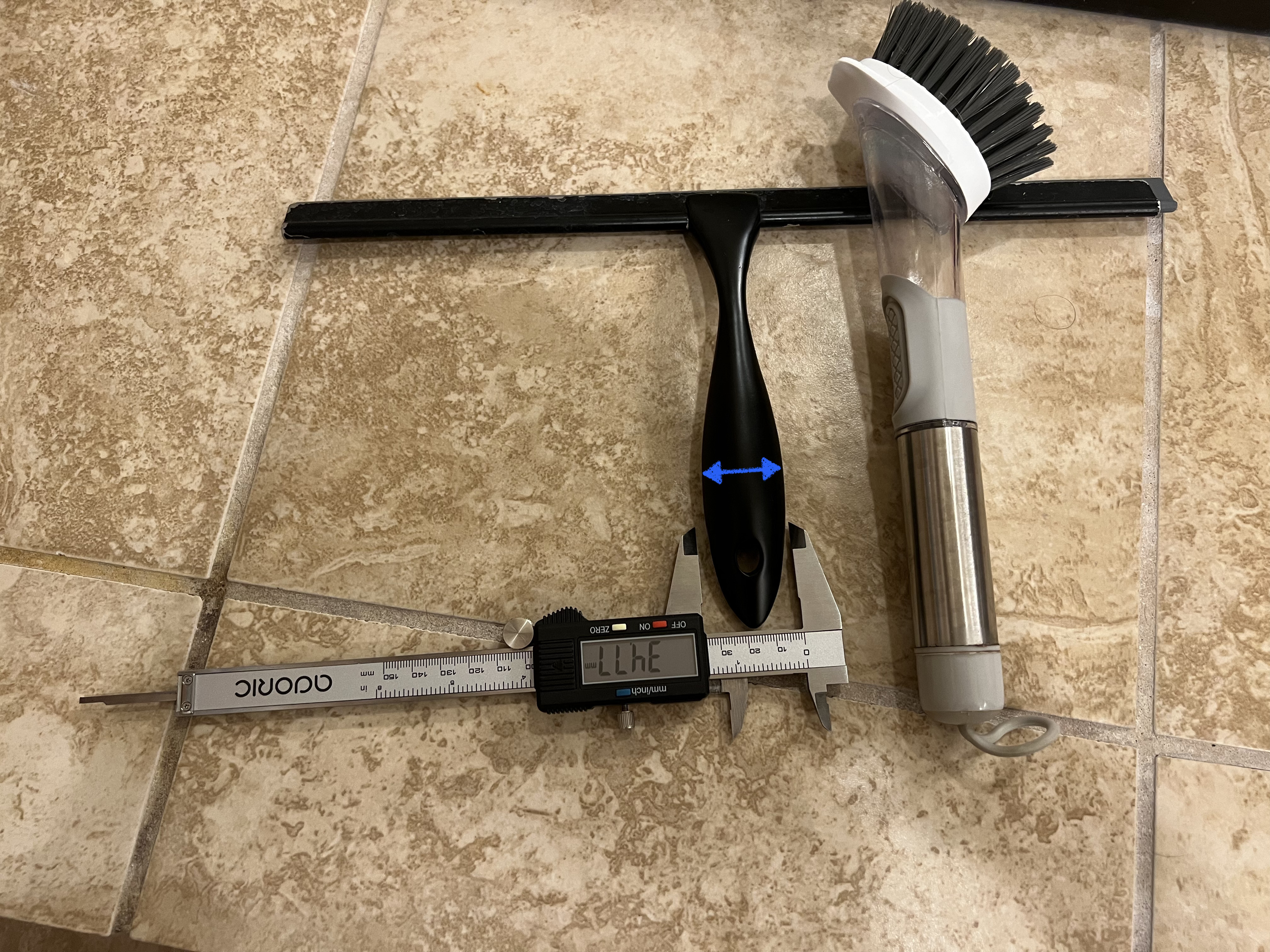 Photograph of measurements of shower accessories with handles including squeegee and cleaning brush