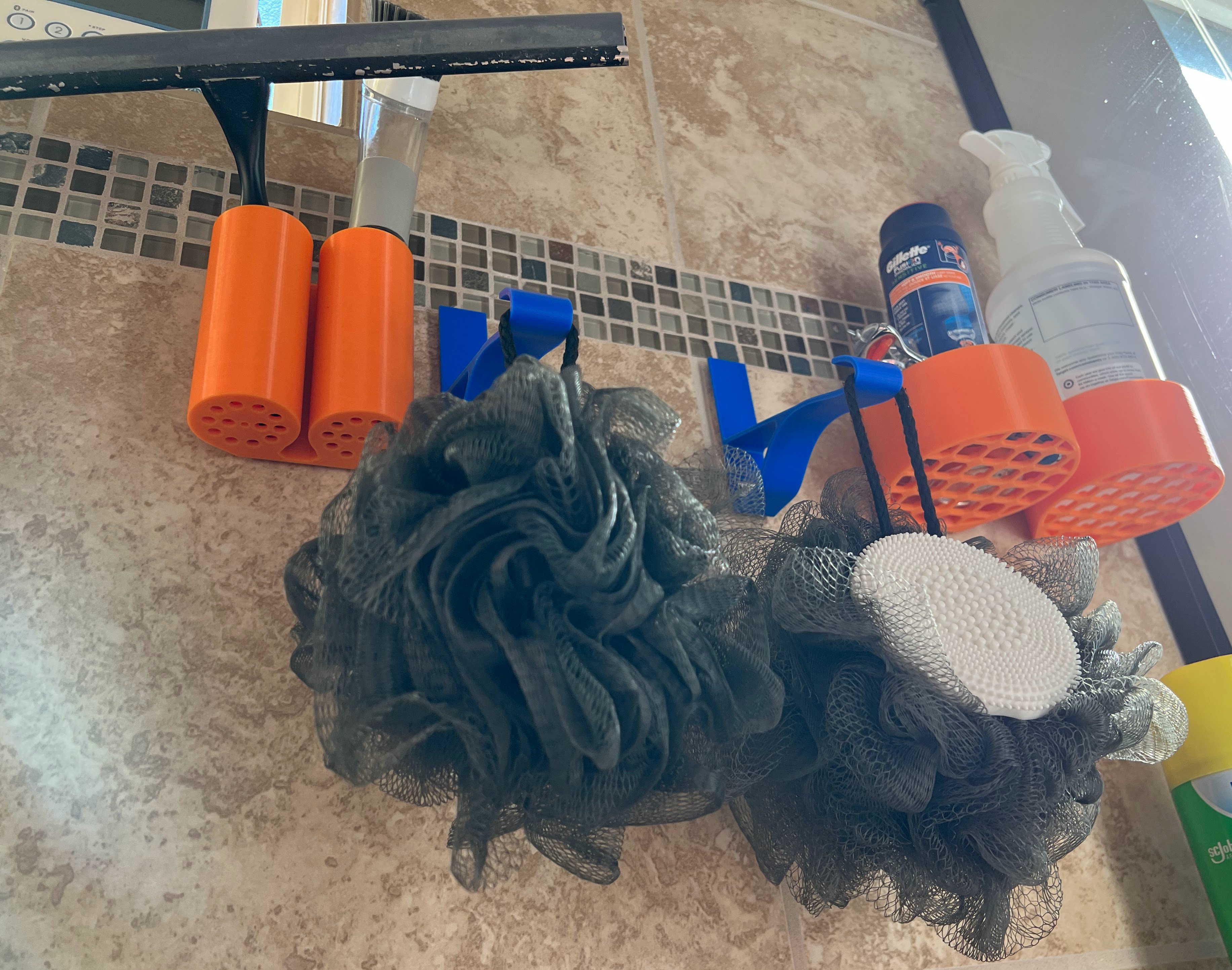 Photograph of functional 3D printed shower wall holders showing the underside